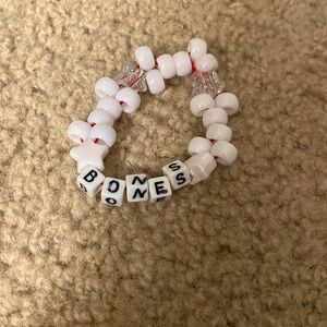 White Kandi. (Can’t say what it says on it or poshmark will think it’s real)